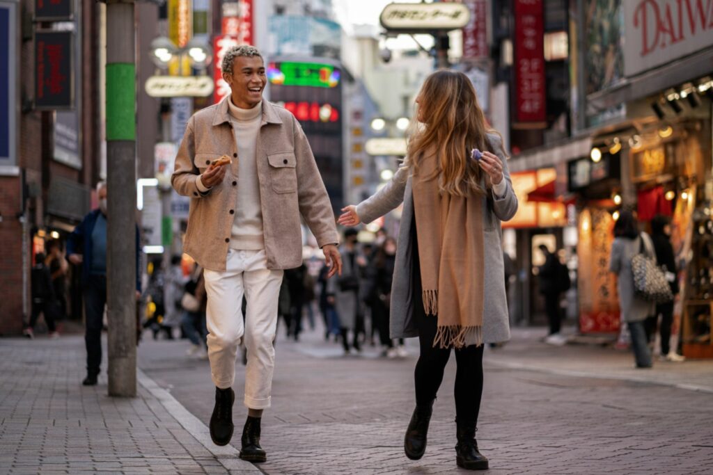 Couple walking through a lively street in Tokyo